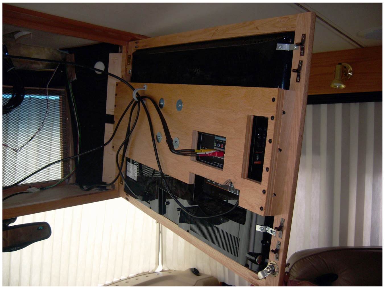front-overhead-tv-swinging-cabinet Front overhead TV swinging cabinet opened to display wiring